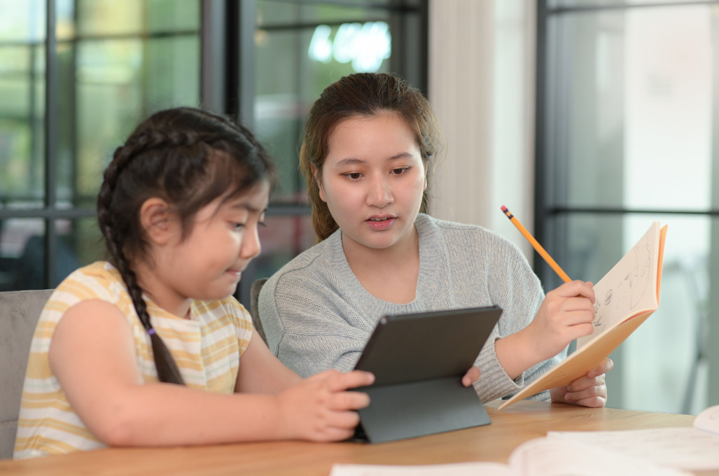 Asian girls study with a tutor, private lessons at home, sis